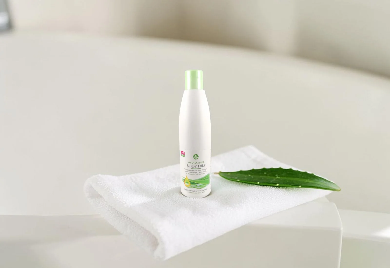 Le’Spa hydrating body milk on the edge of a bath with aloe vera